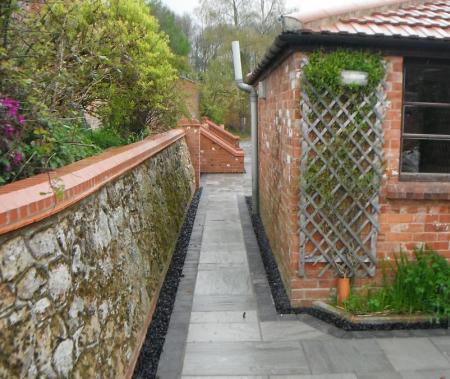 original lime mortar retining wall rebuilt and restored to its former glory