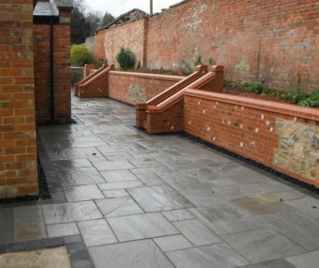 newly paved patio with steps providing easy access to rebuilt raised beds