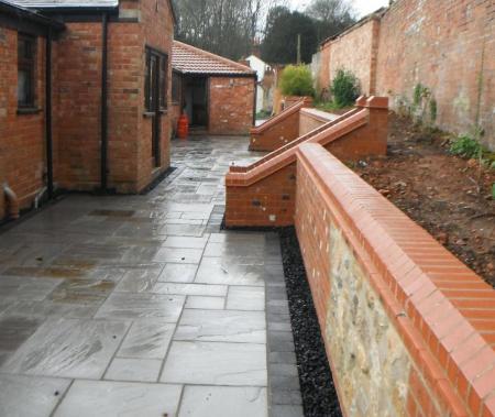 retaining wall has been rebuilt to create a useful raised bed