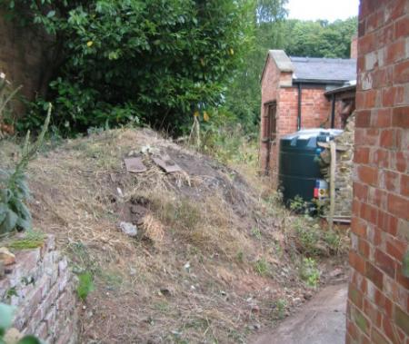 Collapsed retaining wall mud needs to be removed and wall rebuilt